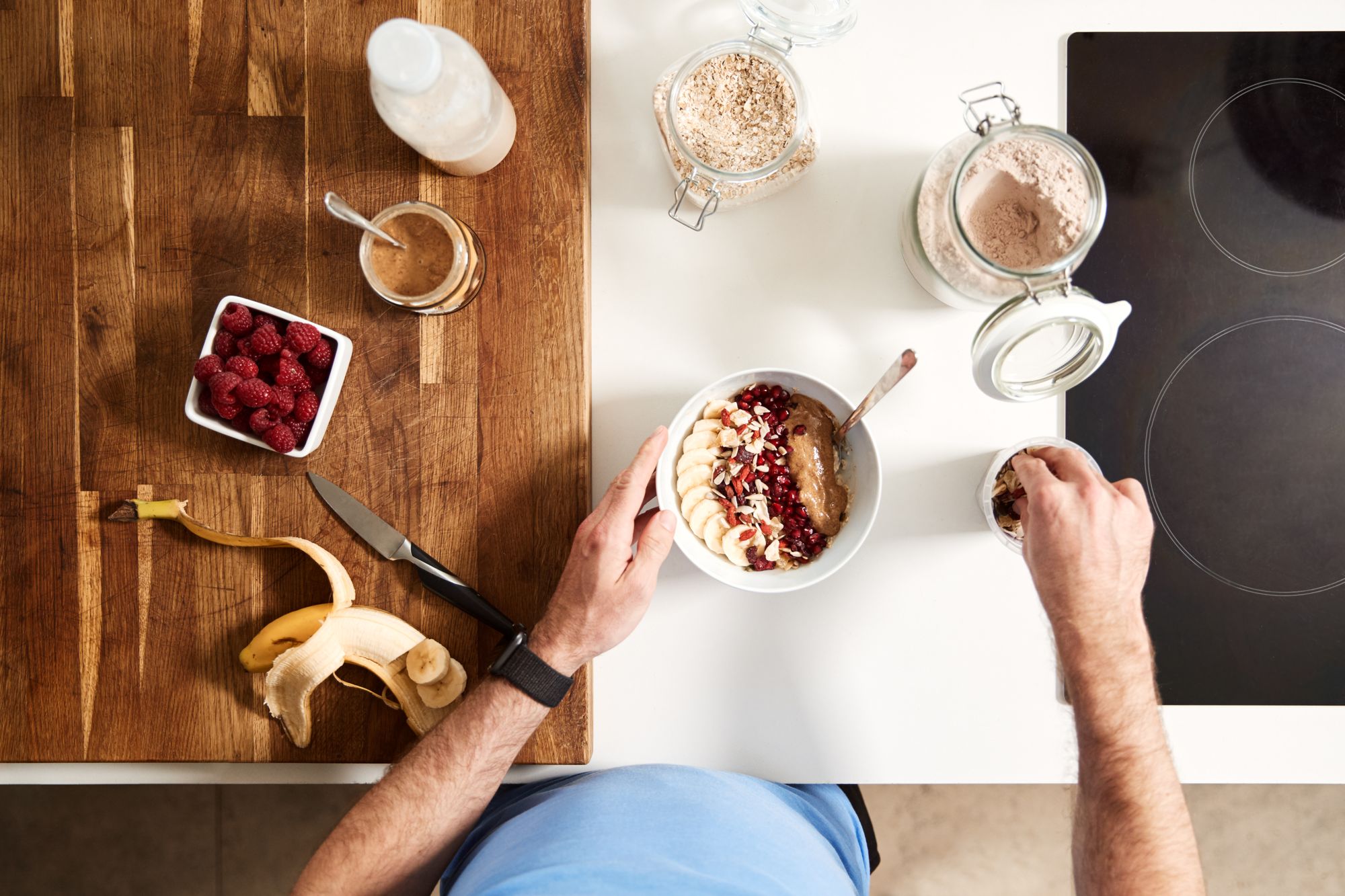 Overhead Shot Of Man Preparing Healthy Breakfast At Home After Exercise