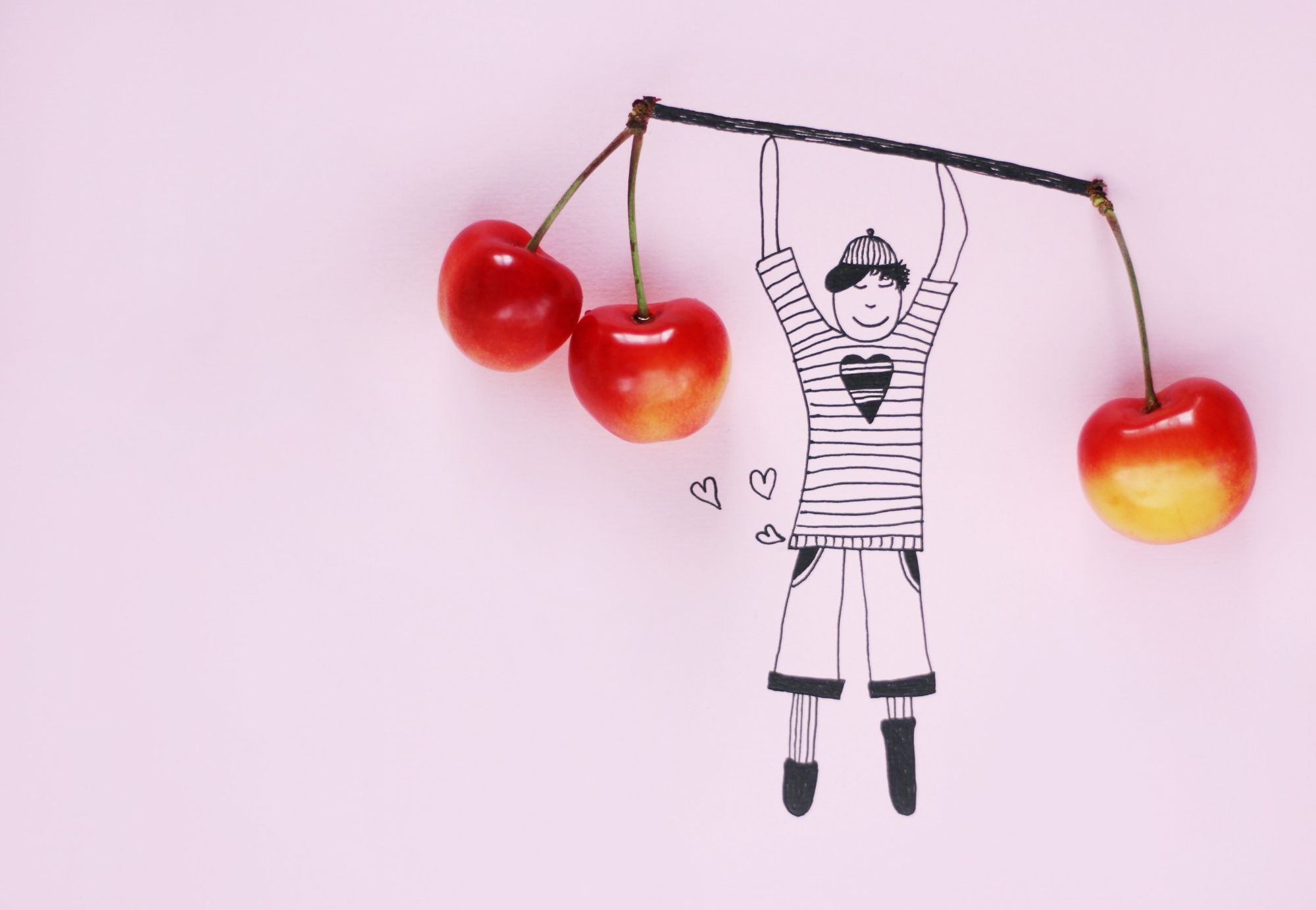 An illustration of a boy lifts weights of real cherries