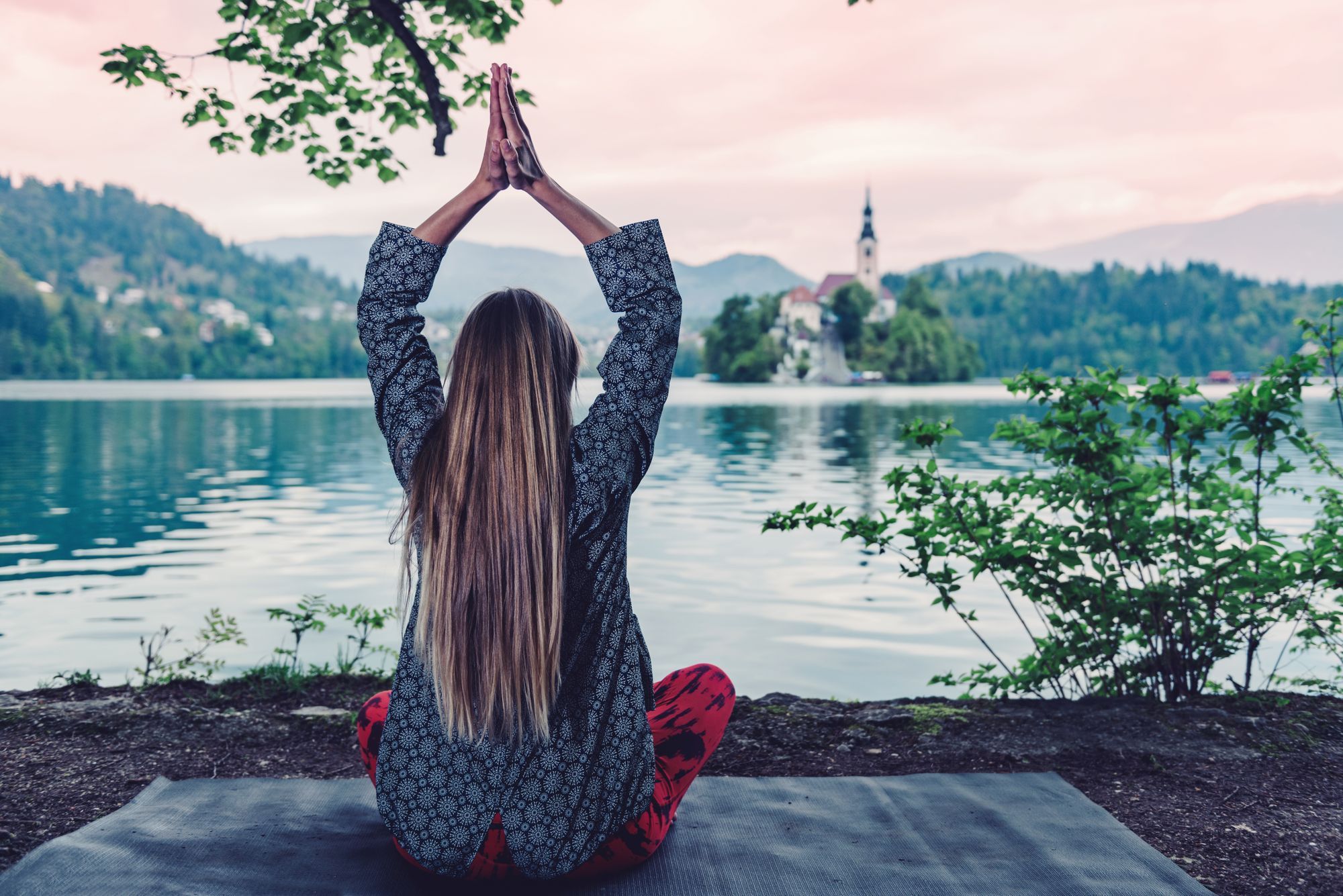 Woman mediating by the lake