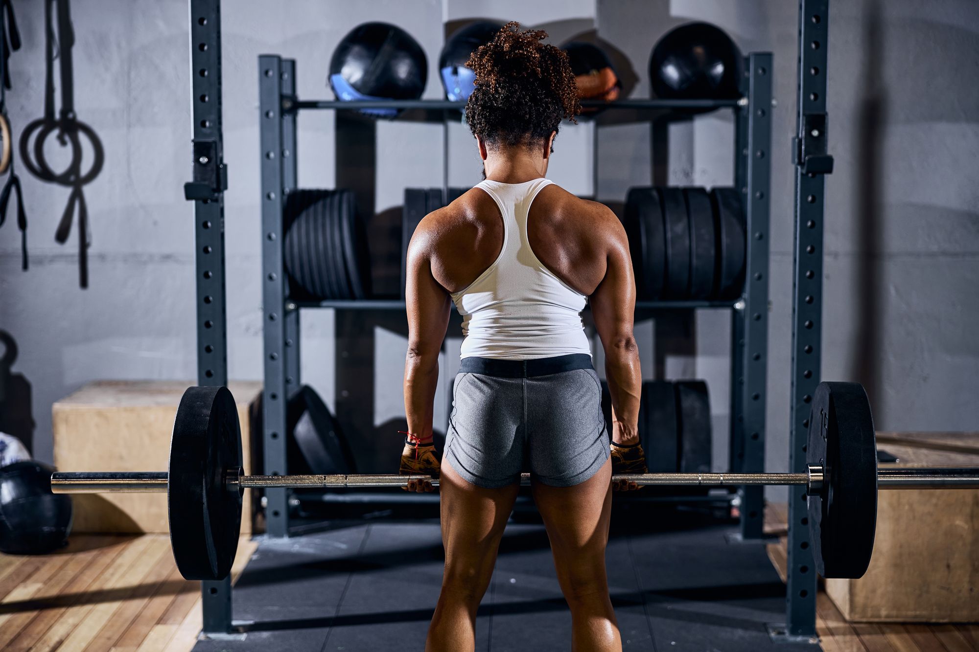 Strong sporty female doing the weight-lifting exercise