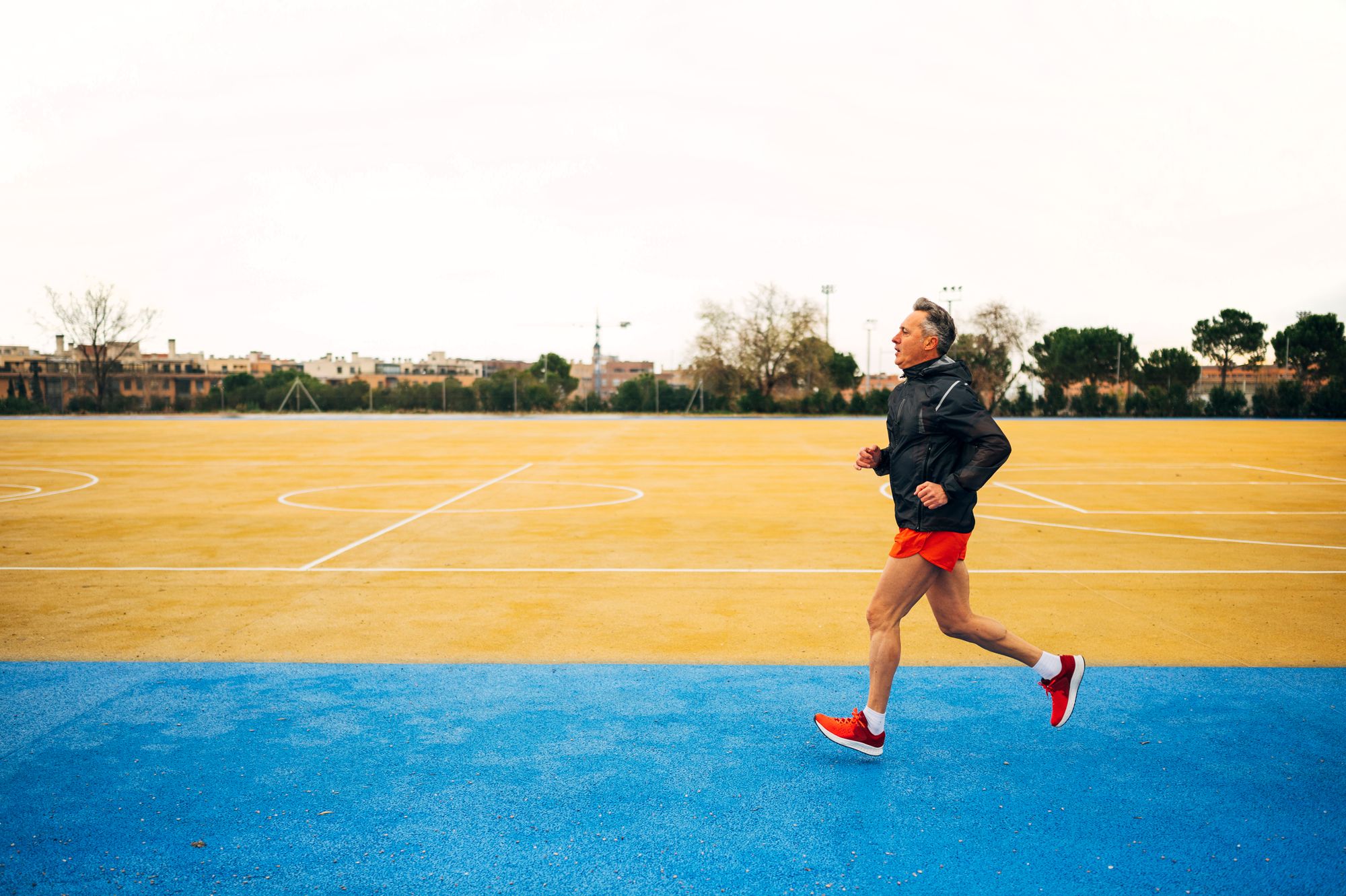 Senior retired man runs and performs exercise