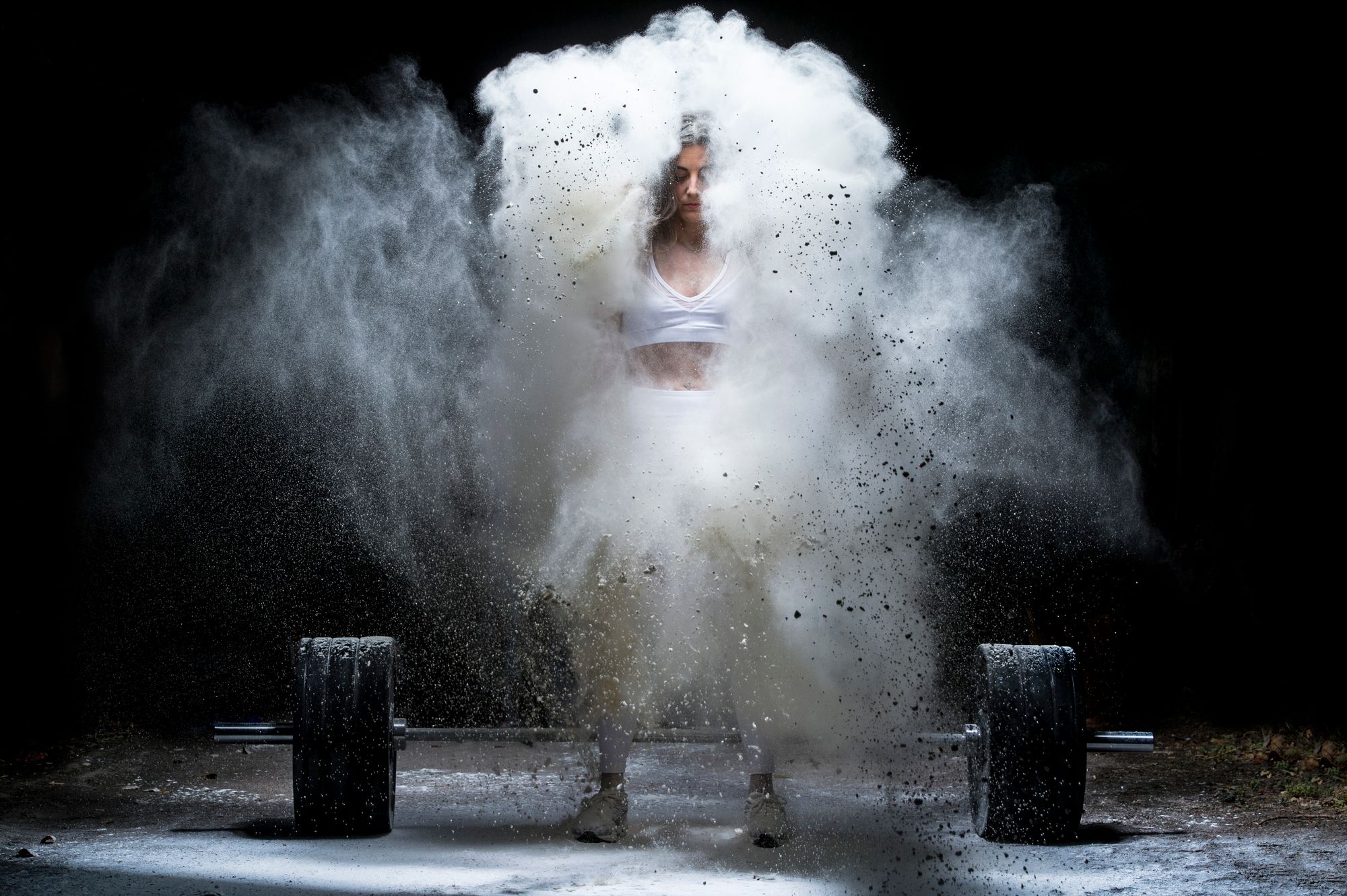 Woman working out with weights in the gym