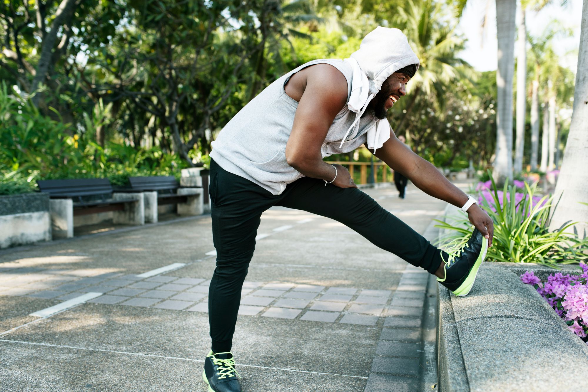 African descent man stretching at the park