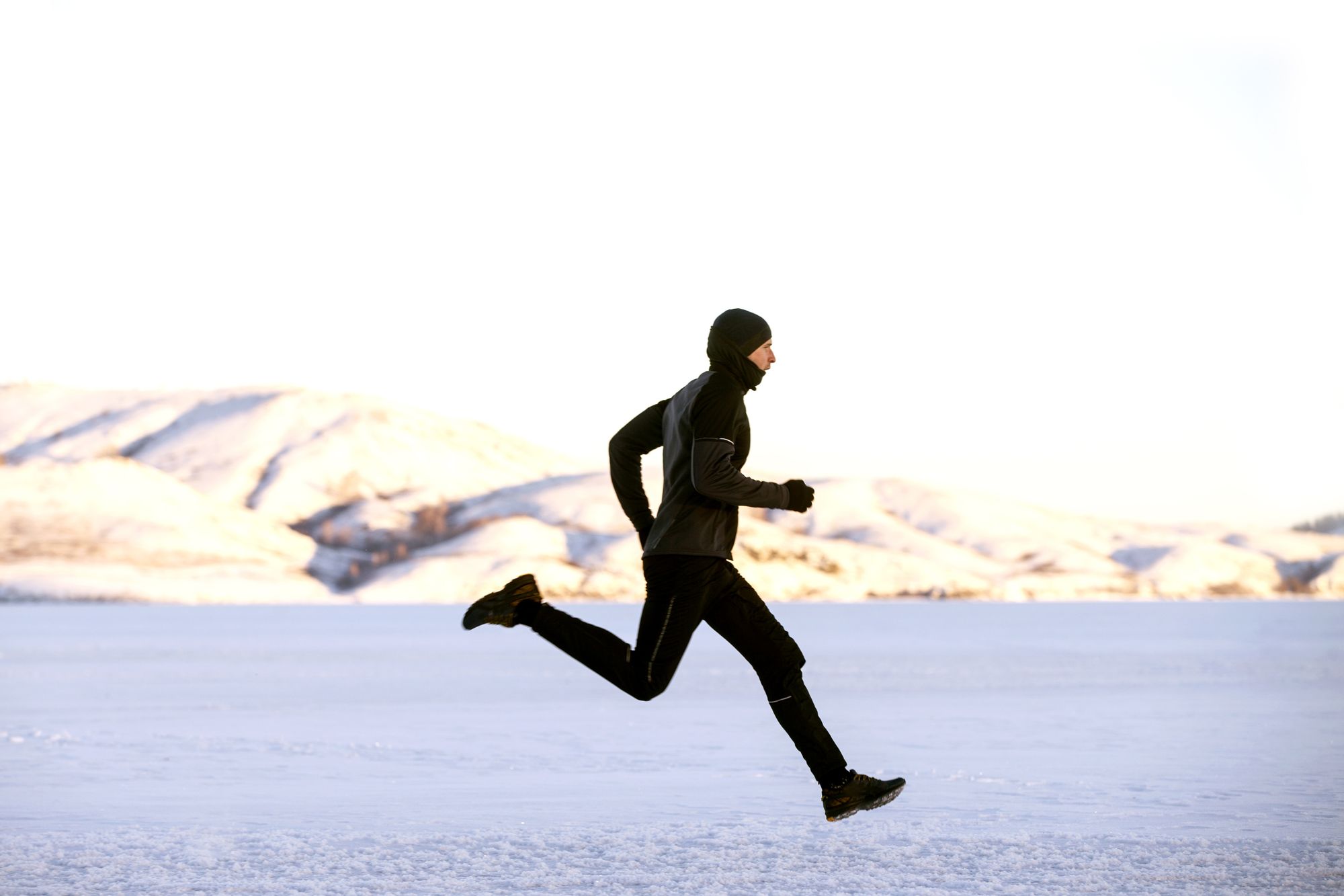 men athlete runner running winter trail snow