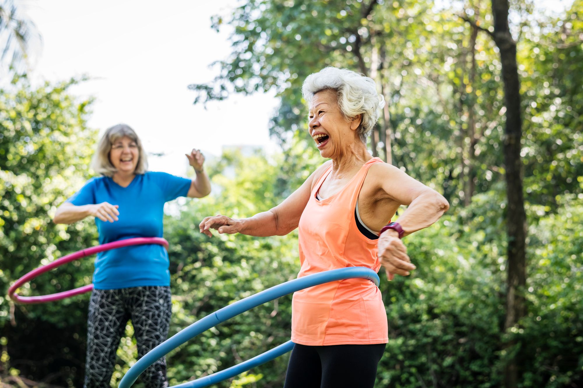 Senior women exercising with a hula hoop