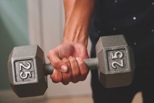 A close up of a hand shot holding a dumbbell