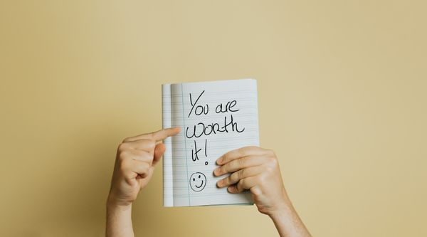 A writing on a notebook that says "You are worth it!" world mental health day!